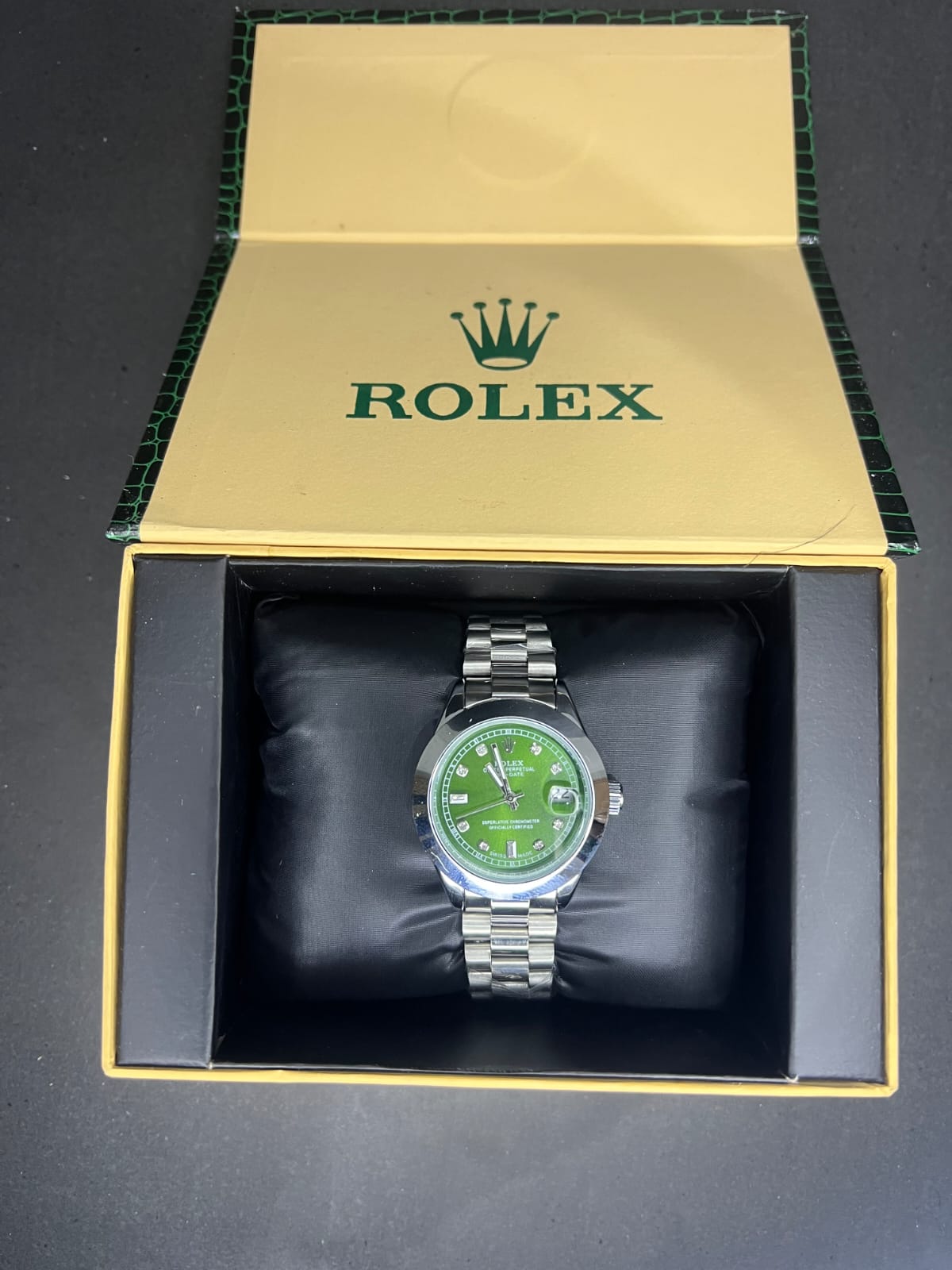 Rolex Oyster Perpetual Cosmograph Daytona with a black dial, gold casing, and a black strap. (Copy) (Copy) (Copy)