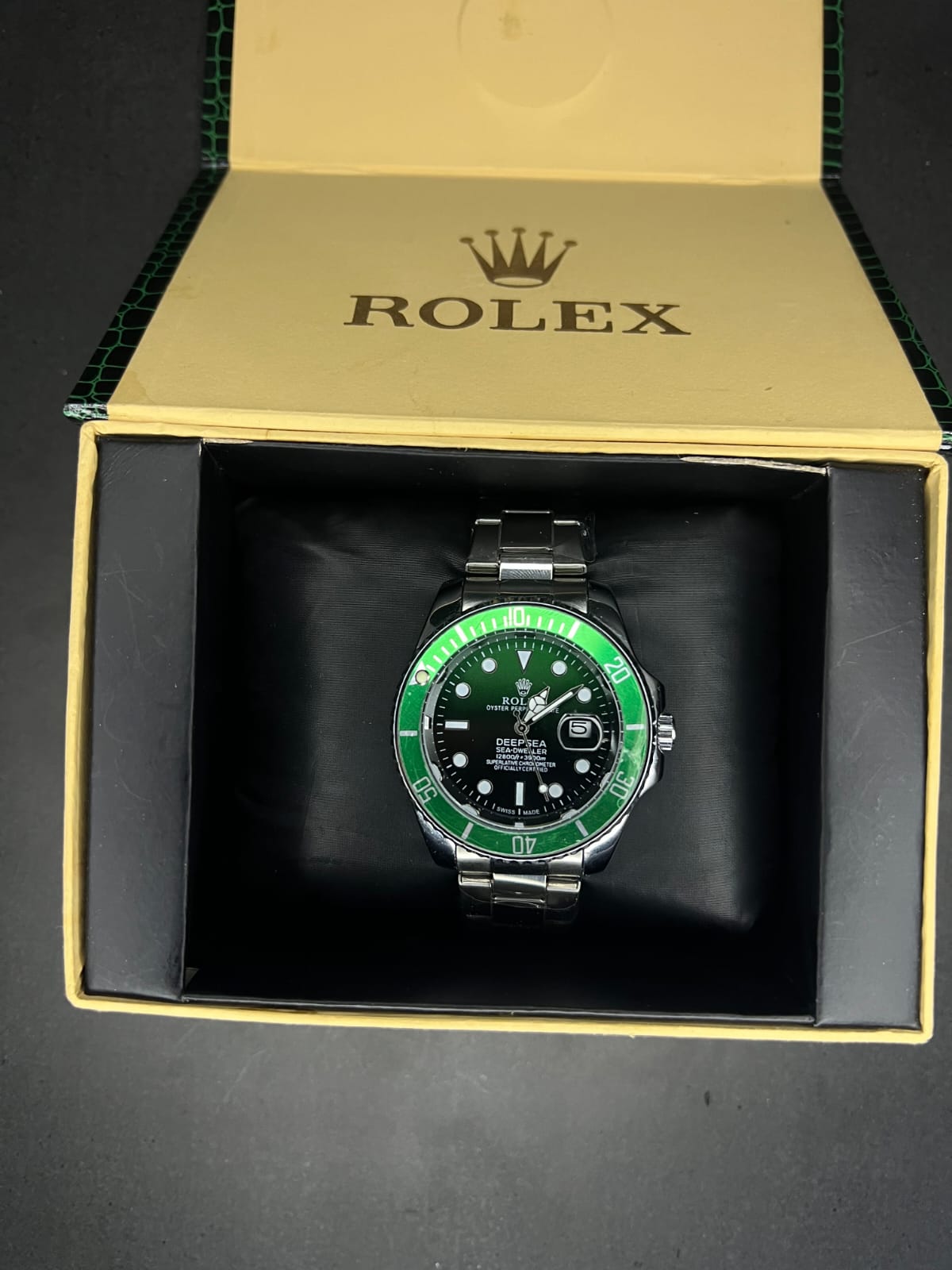 Rolex Oyster Perpetual Cosmograph Daytona with a black dial, gold casing, and a black strap. (Copy) (Copy)