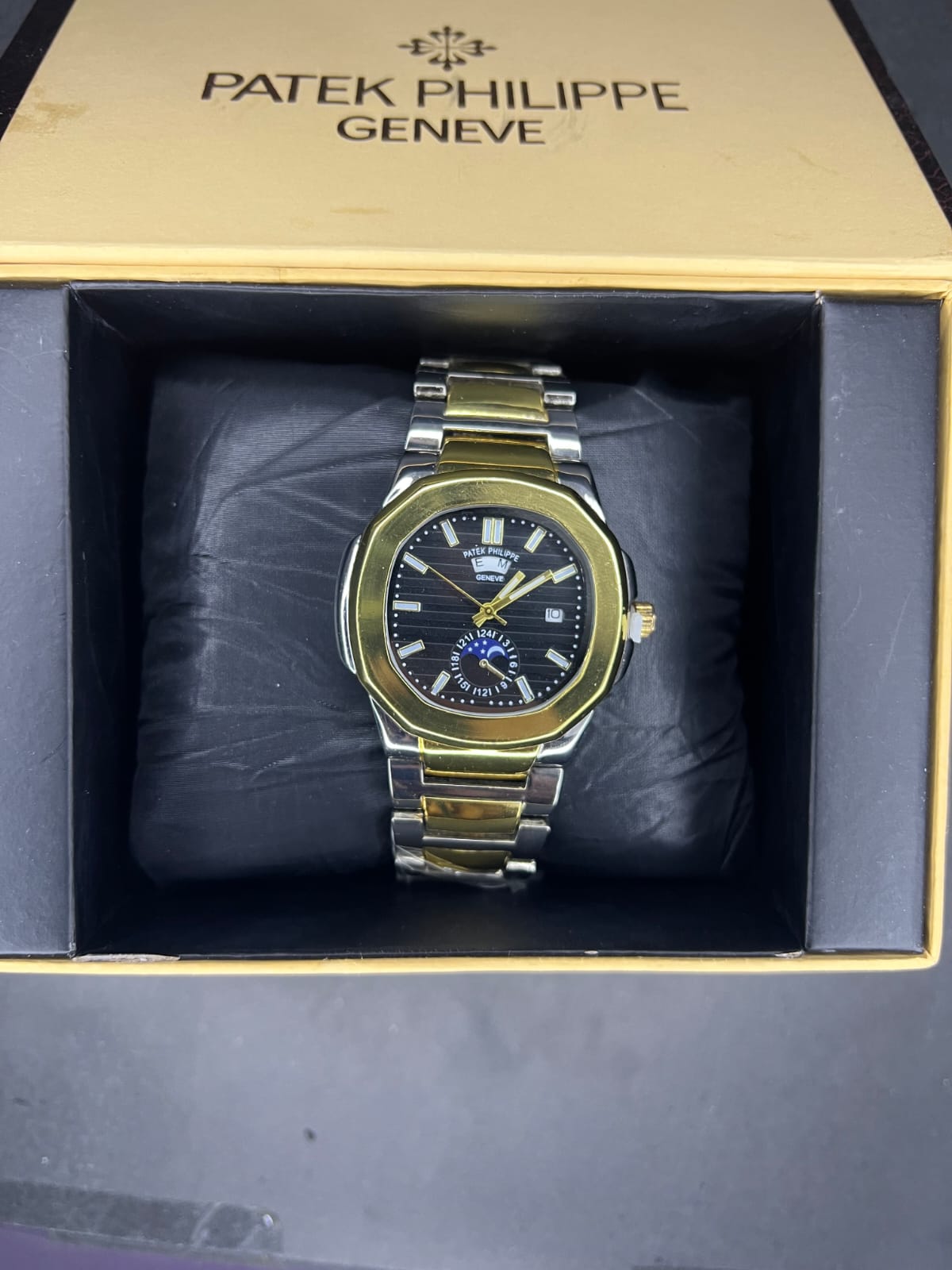 Patek Philippe Nautilus watch with a two tone bracelet and a moon phase