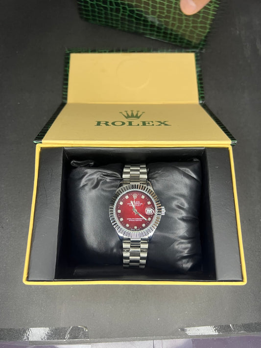 Rolex Oyster Perpetual Cosmograph Daytona with a black dial, gold casing, and a black strap. 