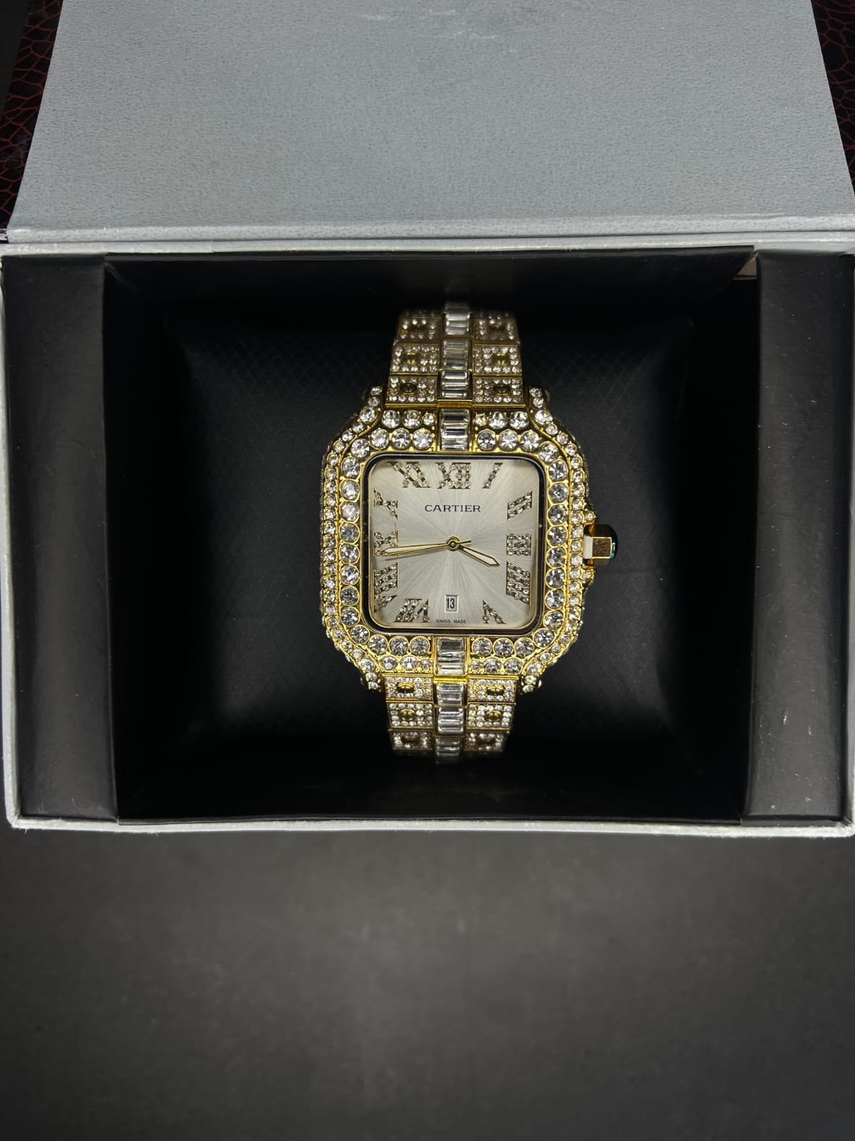 Cartier Santos two-tone custom "iced out" wristwatch with a square dial and Roman numerals.